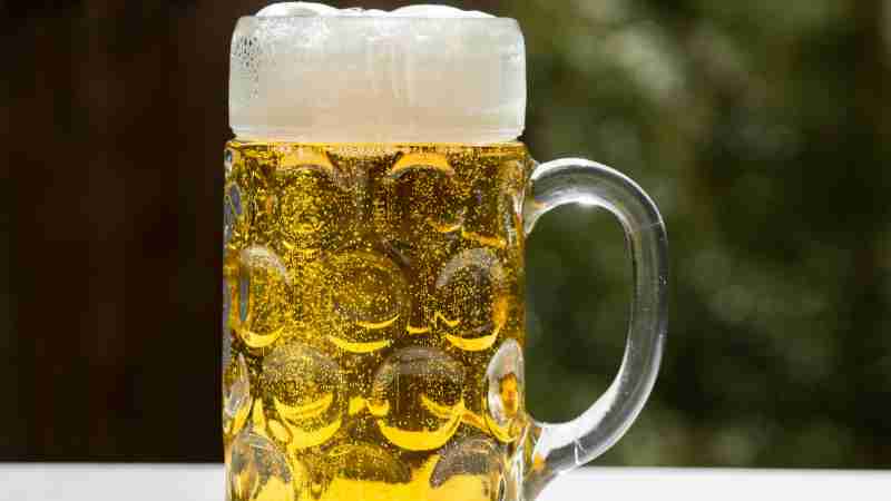 A refreshing glass of golden lager beer with frothy head, served outdoors in Munich, Germany., tags: berliner - pexel
